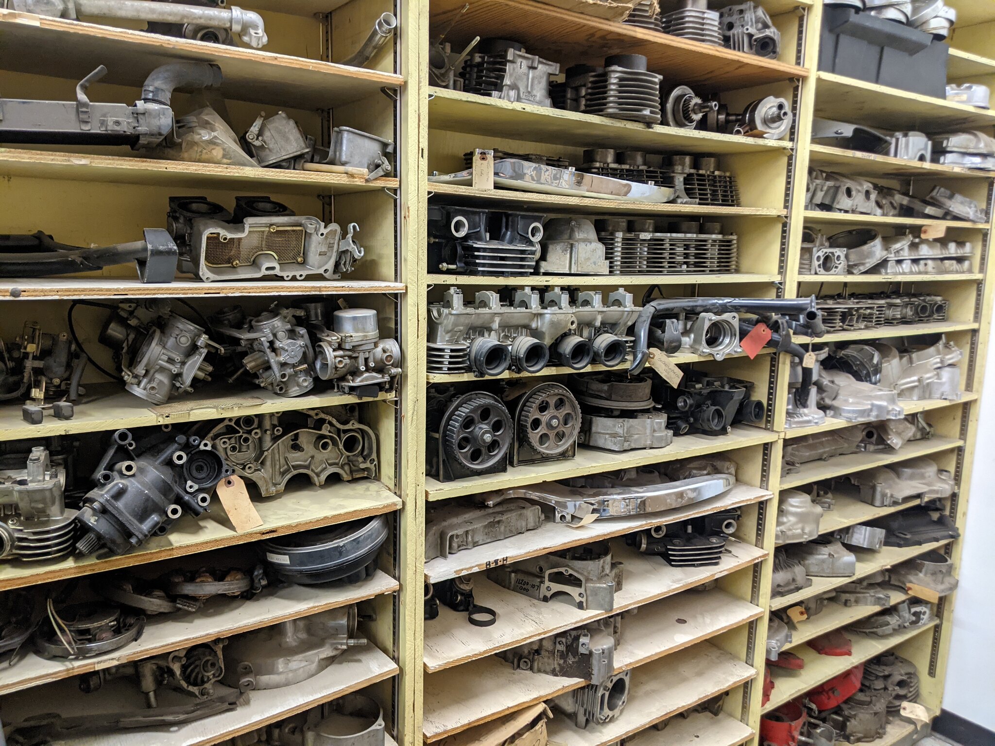 Old motorcycle parts out on a shelf